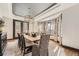 Formal dining room featuring stylish light fixture, tray ceiling, and large windows at 5352 Pinyon Jay Rd, Parker, CO 80134