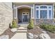 Charming front entrance with a well-manicured garden, leading to a welcoming front door at 5352 Pinyon Jay Rd, Parker, CO 80134