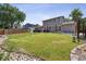 Large backyard with manicured lawn and patio area for outdoor entertaining at 8445 Lamar Dr, Arvada, CO 80003