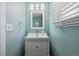 Charming powder room featuring a modern vanity with stylish fixtures and ample natural light at 8445 Lamar Dr, Arvada, CO 80003