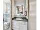 Updated bathroom featuring a modern vanity with a lighted mirror and contemporary fixtures at 8445 Lamar Dr, Arvada, CO 80003