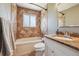 The bathroom features a tiled tub and shower combo and granite vanity at 8445 Lamar Dr, Arvada, CO 80003