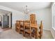 Sunlit dining room featuring a wood table, seating for eight, and an ornamental wooden cabinet at 8445 Lamar Dr, Arvada, CO 80003