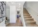 Welcoming entryway featuring modern lighting and access to the kitchen and staircase at 8445 Lamar Dr, Arvada, CO 80003