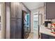 Functional laundry area with full-size washer and dryer, and ample storage in dark cabinets at 8445 Lamar Dr, Arvada, CO 80003
