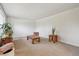 Bright living room featuring neutral carpet and minimalist decor at 8445 Lamar Dr, Arvada, CO 80003