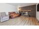 Cozy living room featuring a brick fireplace, hardwood floors, and comfortable seating at 8445 Lamar Dr, Arvada, CO 80003