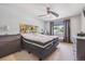 Spacious main bedroom with two beds, two dressers, a ceiling fan, and a window view at 8445 Lamar Dr, Arvada, CO 80003