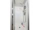 Modern shower stall featuring white tile, a rainfall showerhead, and sleek fixtures at 8445 Lamar Dr, Arvada, CO 80003