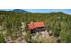 Aerial view of a home nestled among the trees showcasing the expansive property at 116 Ramona Rd, Golden, CO 80403