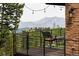 Cozy outdoor balcony with a mountain view features stone accents and comfortable seating at 116 Ramona Rd, Golden, CO 80403