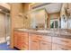 Bathroom features a granite countertop, double sinks, and a glass-enclosed shower at 116 Ramona Rd, Golden, CO 80403