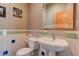 Charming powder room with patterned tile accents and a pedestal sink at 116 Ramona Rd, Golden, CO 80403