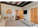 Bedroom featuring decor, access to a sitting room, and an exposed ceiling at 116 Ramona Rd, Golden, CO 80403