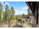 A cozy deck featuring outdoor seating with stunning views of the surrounding trees and mountains in the distance at 116 Ramona Rd, Golden, CO 80403