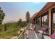 Expansive wooden deck features comfortable seating with mountain views and a relaxing hot tub at 116 Ramona Rd, Golden, CO 80403