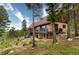 The exterior features a stone facade, a metal roof, and an outdoor living area at 116 Ramona Rd, Golden, CO 80403