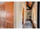 Hallway featuring wood floors, a wood ceiling, and a view into a tiled bathroom at 116 Ramona Rd, Golden, CO 80403