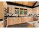 Bright kitchen features modern appliances, wood cabinets, granite counters, and a large window with a wooded view at 116 Ramona Rd, Golden, CO 80403