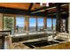 Open kitchen with sleek countertops, modern appliances, a large island, and stunning views through expansive windows at 116 Ramona Rd, Golden, CO 80403