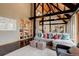Elegant living room with soaring ceilings, exposed beams, a comfortable sofa, and large windows to enjoy the view at 116 Ramona Rd, Golden, CO 80403
