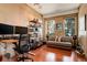 Bright home office with wood floors, natural light, a modern desk setup, and a comfortable seating area at 116 Ramona Rd, Golden, CO 80403