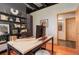 Office space with natural wood desk, storage shelving, and hardwood floors at 116 Ramona Rd, Golden, CO 80403
