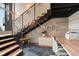 Modern staircase with metal railings, natural wood treads, and adjacent workspace at 116 Ramona Rd, Golden, CO 80403