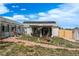 Charming backyard featuring a patio, rock pathway, and a neatly fenced yard at 34280 Columbine E Trl, Elizabeth, CO 80107