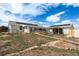 The home's backyard showing the patio, covered seating area, shed, and landscaping at 34280 Columbine E Trl, Elizabeth, CO 80107