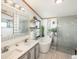 Modern bathroom featuring a double vanity, soaking tub, and glass-enclosed shower at 34280 Columbine E Trl, Elizabeth, CO 80107