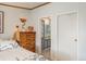 Bedroom view showcasing a wood dresser and a doorway leading to the bathroom at 34280 Columbine E Trl, Elizabeth, CO 80107