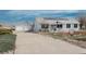 Charming home featuring a detached garage and solar panels with a well-manicured lawn and long driveway at 34280 Columbine E Trl, Elizabeth, CO 80107