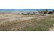 Wide shot of a single-Gathering home with a detached garage, dry grass yard, and a blue sky background at 34280 Columbine E Trl, Elizabeth, CO 80107