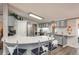 Updated kitchen with stainless steel appliances, white quartz countertops, and decorative barstools at 34280 Columbine E Trl, Elizabeth, CO 80107