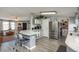 Open-concept kitchen area with stone countertops and stainless steel refrigerator at 34280 Columbine E Trl, Elizabeth, CO 80107