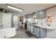Well-lit kitchen features stainless steel appliances, wood floors, and custom backsplash and dishwasher panel at 34280 Columbine E Trl, Elizabeth, CO 80107