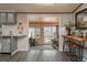 Open-concept view from kitchen into bonus room boasting sliding glass doors and outdoor views at 34280 Columbine E Trl, Elizabeth, CO 80107