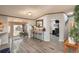 Well-lit interior view featuring a breakfast bar, wooden table, and access to a sun room and office space at 34280 Columbine E Trl, Elizabeth, CO 80107