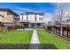 Spacious backyard with lush green lawn, modern home architecture, and serene outdoor setting at 2224 W 37Th Ave, Denver, CO 80211