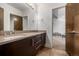 Bathroom boasts a double sink vanity with dark wood cabinets and a large mirror, offering ample space at 2224 W 37Th Ave, Denver, CO 80211