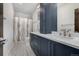 Bathroom with double sink vanity, modern fixtures, and tiled shower with patterned curtain at 2224 W 37Th Ave, Denver, CO 80211