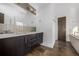 Bathroom featuring double sinks, modern fixtures, dark wood cabinets, tile floors and a separate soaking tub at 2224 W 37Th Ave, Denver, CO 80211