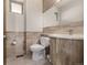 Bathroom featuring a toilet, stone countertop, and a vessel sink with modern fixtures and tile flooring at 2224 W 37Th Ave, Denver, CO 80211