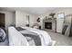 View of a primary bedroom, highlighting a fireplace, accent chair, and a large bed with a gray and white blanket at 2224 W 37Th Ave, Denver, CO 80211