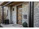 Charming entryway featuring a sleek wood door, stone cladding, and modern address numbers at 2224 W 37Th Ave, Denver, CO 80211