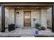 Inviting front entrance with a stylish wood door, stone accents, and modern design details at 2224 W 37Th Ave, Denver, CO 80211