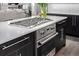 Close-up of a kitchen island featuring a cooktop and built-in oven with stainless steel appliances and a light countertop at 2224 W 37Th Ave, Denver, CO 80211