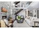 Bright and airy living room featuring a stone accent wall, fireplace, and open staircase at 2224 W 37Th Ave, Denver, CO 80211