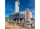 Modern commercial building with a tall tower, featuring outdoor dining and recreational areas at 1645 Tamarac St, Denver, CO 80220